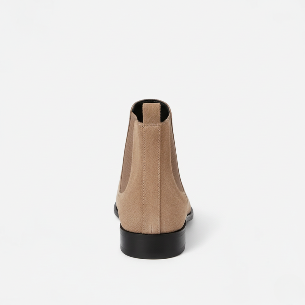 Back view of men's beige suede ankle boots showing elastic gussets and low block heel with pull-tab