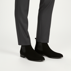 Black suede Chelsea ankle boots for men worn showing square toe design and classic pull-on style