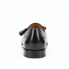 Back view of black leather tassel loafers displaying heel construction and quality stitching detail