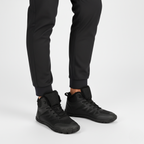 Black insulated barefoot winter boots worn showing wide toe box and flexible zero-drop sole for natural movement