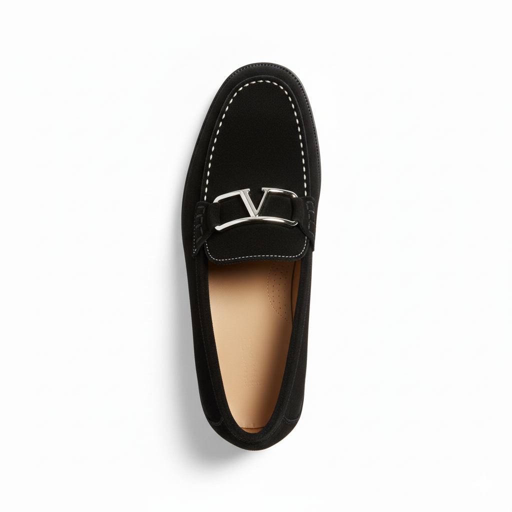 Top view of men's black suede loafers showing decorative metal hardware and contrast stitching detail
