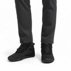 Black minimalist barefoot hiking boots worn showing wide toe box and flexible design for natural movement