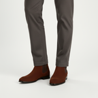 Brown suede Chelsea ankle boots for men worn showing square toe design and classic pull-on style