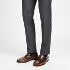 Brown leather formal loafers for men worn with tailored suit trousers for business professional style