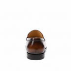 Back view of brown men's slip-on dress loafers with premium leather construction and low heel