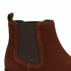 Close-up of men's brown suede Chelsea boots showing elastic side panel and premium construction detail