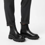 Close-up of black platform boot showing elastic panel and deep tread rubber sole