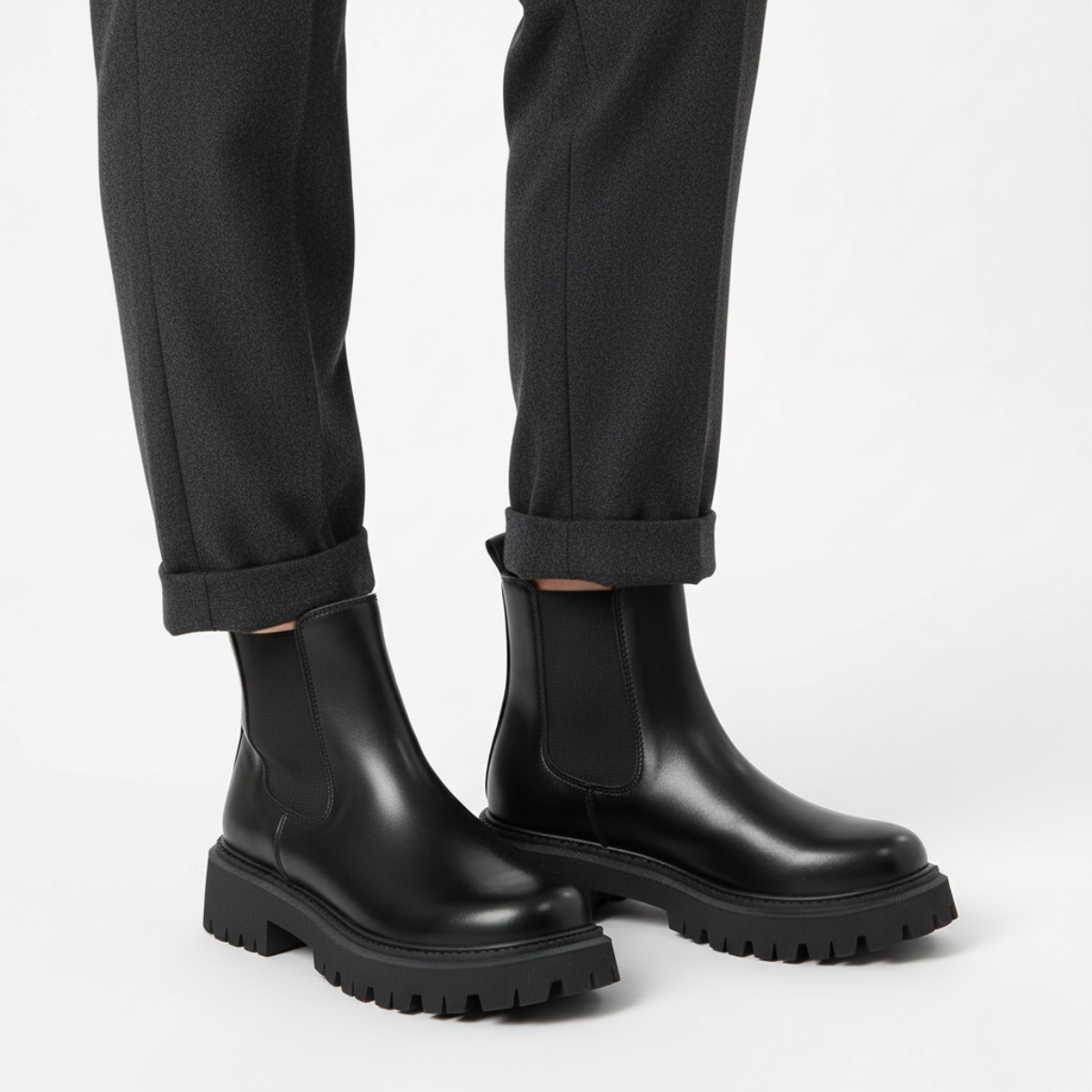 Close-up of black platform boot showing elastic panel and deep tread rubber sole