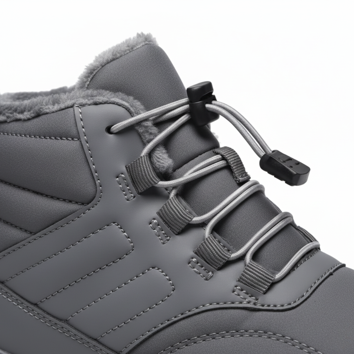 Close-up detail of grey barefoot boot showing quick-lace toggle system and plush fleece lining