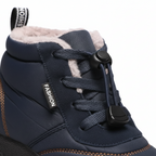 Close-up detail of navy barefoot boot showing quick-lace toggle system and plush fleece lining