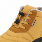 Close-up detail of mustard yellow barefoot boot showing lace-up system and plush fleece collar