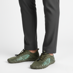 Green flexible barefoot aqua shoes worn showing natural movement design for swimming and water sports