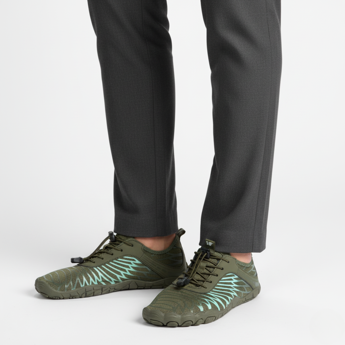 Green flexible barefoot aqua shoes worn showing natural movement design for swimming and water sports