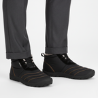 Black insulated barefoot boots for men styled with charcoal trousers for casual winter look