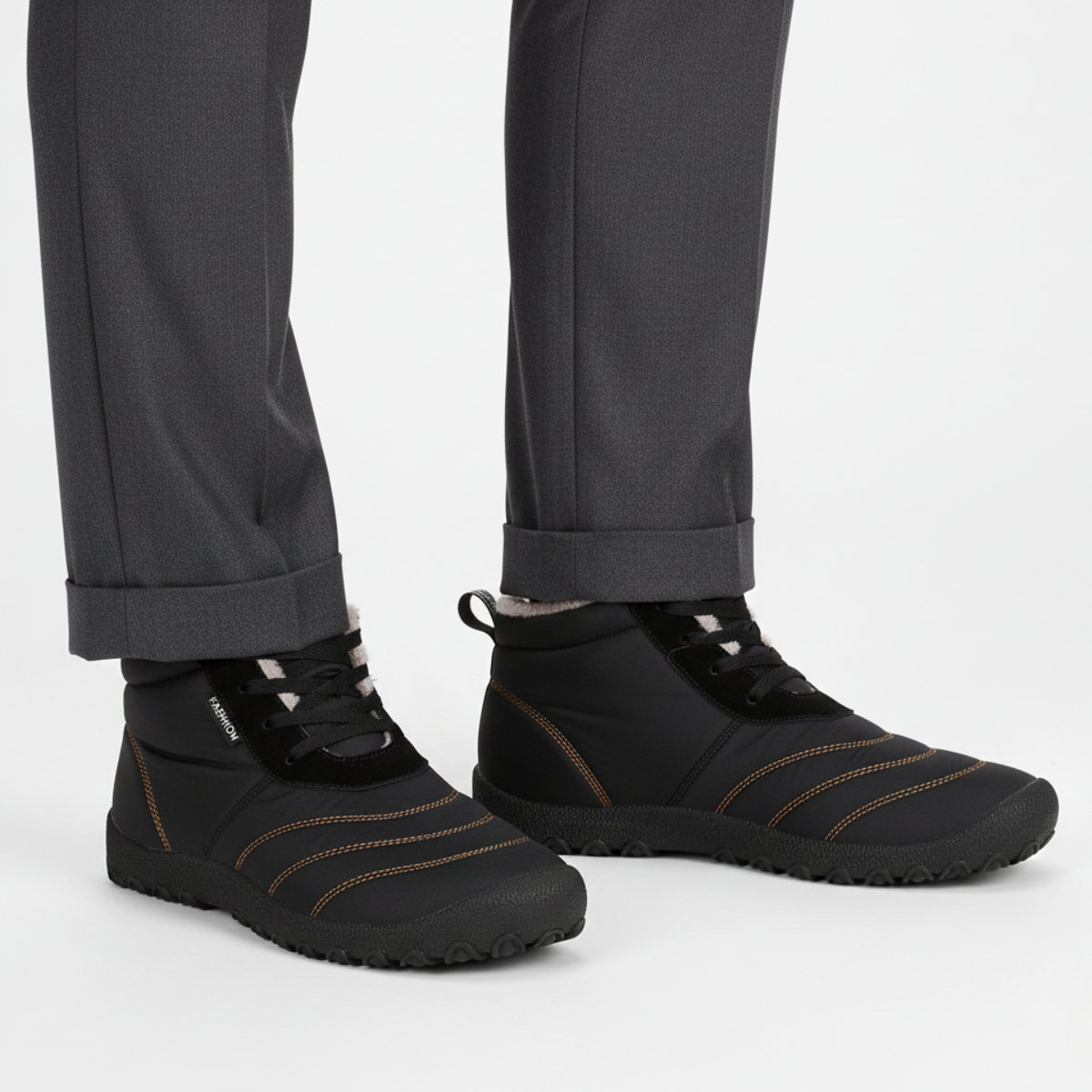 Black insulated barefoot boots for men styled with charcoal trousers for casual winter look
