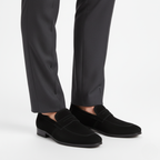 Black suede penny loafers for men styled with charcoal dress trousers for professional look