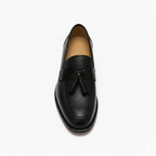 Top view of men's black tassel loafers showing textured vamp design and leather tassel detailing