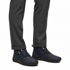 Navy blue insulated barefoot boots for men styled with charcoal trousers for casual winter look