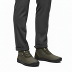 Olive green insulated barefoot boots for men styled with charcoal trousers for casual winter look