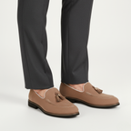 Taupe suede tassel loafers for men styled with charcoal dress trousers for smart-casual business look