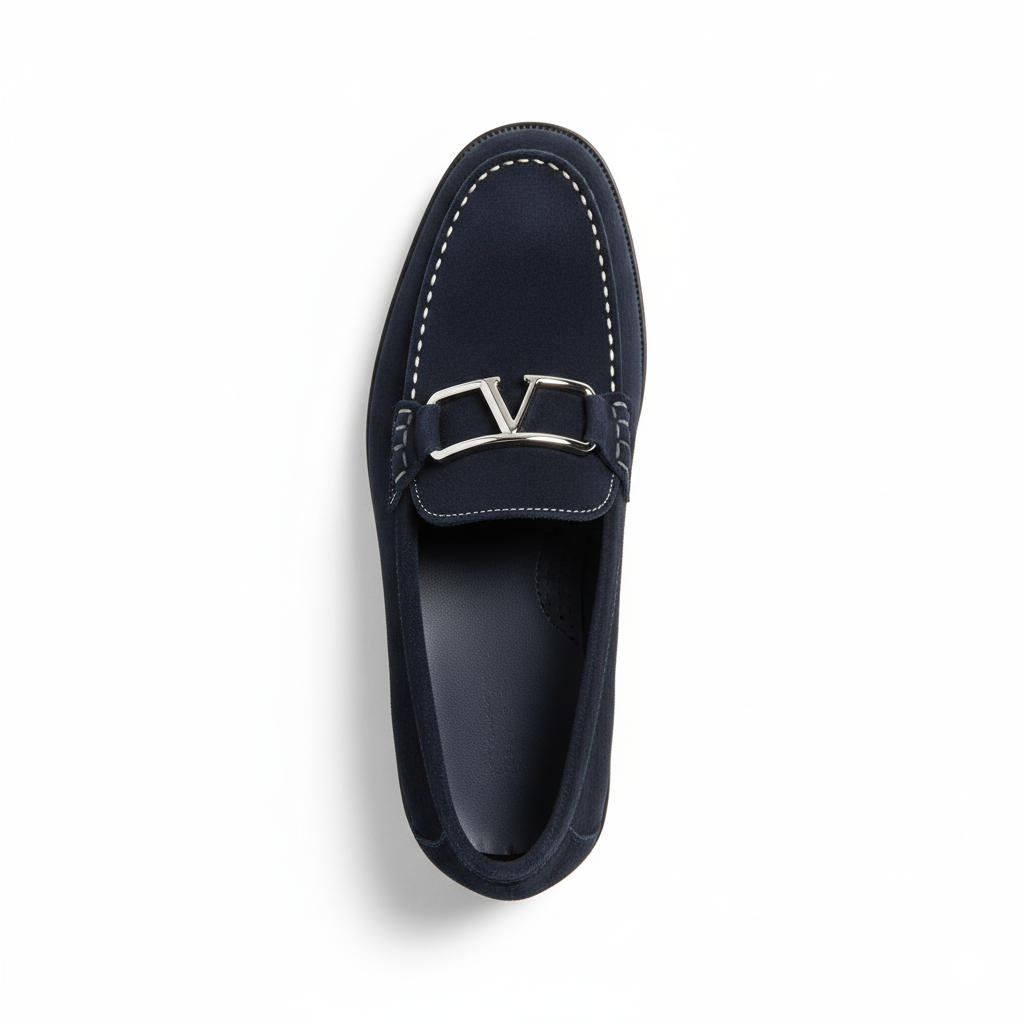 Top view of men's navy suede loafers showing decorative metal hardware and contrast stitching detail