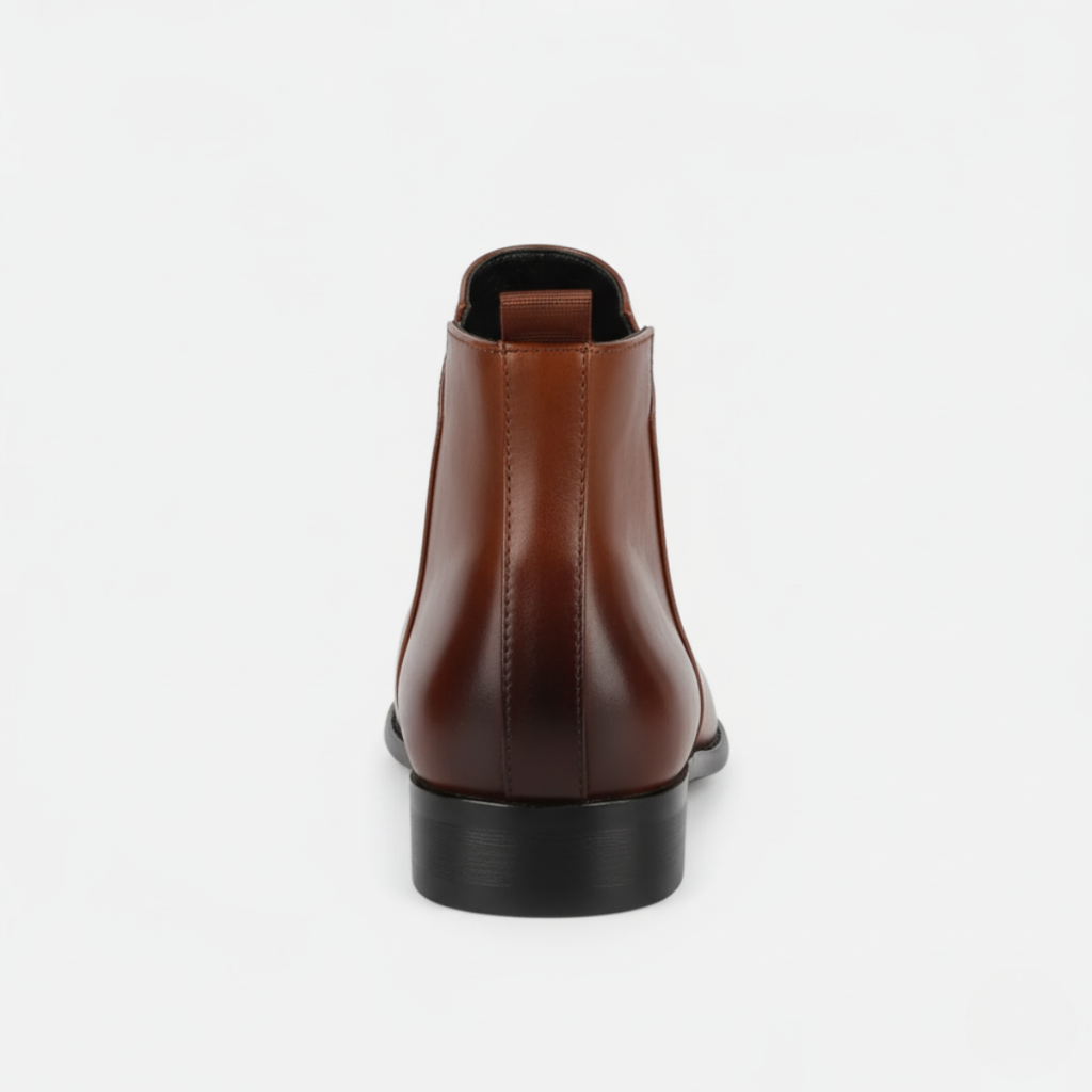 Back view of men's tan leather Chelsea boots showing elastic side panels and low block heel with pull-tab