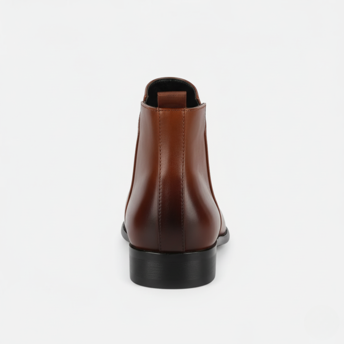 Back view of men's tan leather Chelsea boots showing elastic side panels and low block heel with pull-tab