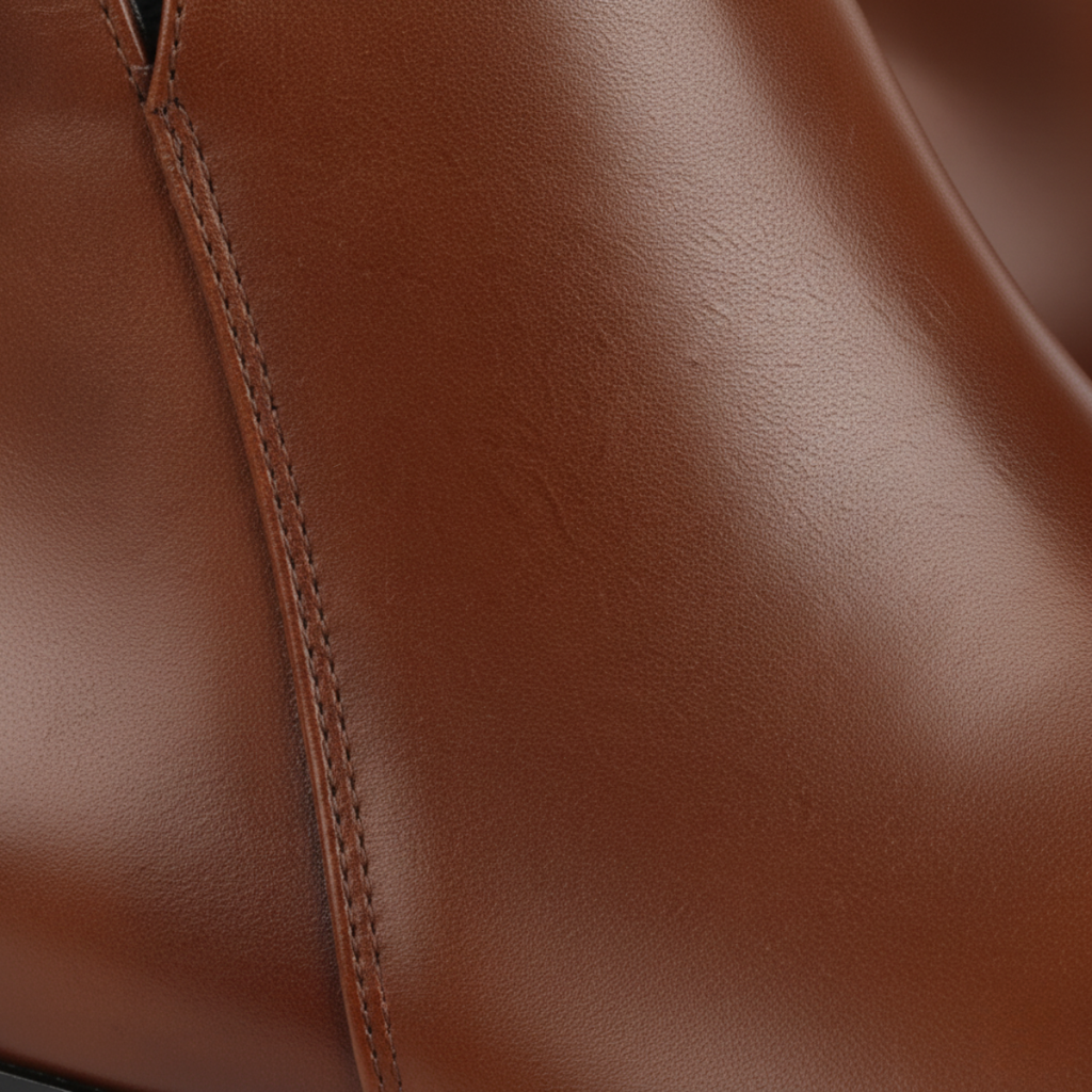 Close-up detail of men's tan leather Chelsea boots showing premium construction quality and smooth finish