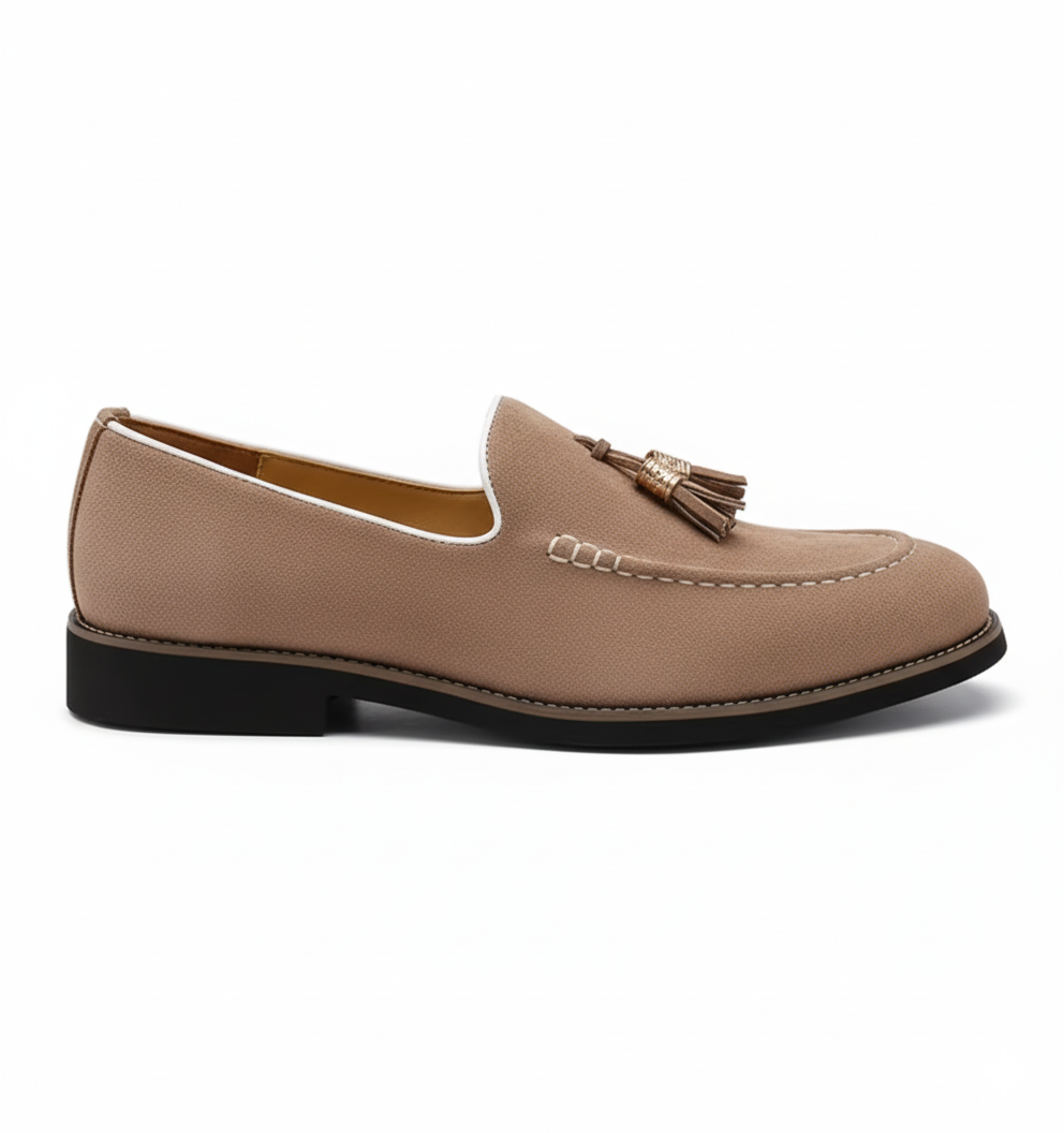 Taupe suede tassel loafers for men with gold metallic detail and white piping, side profile view