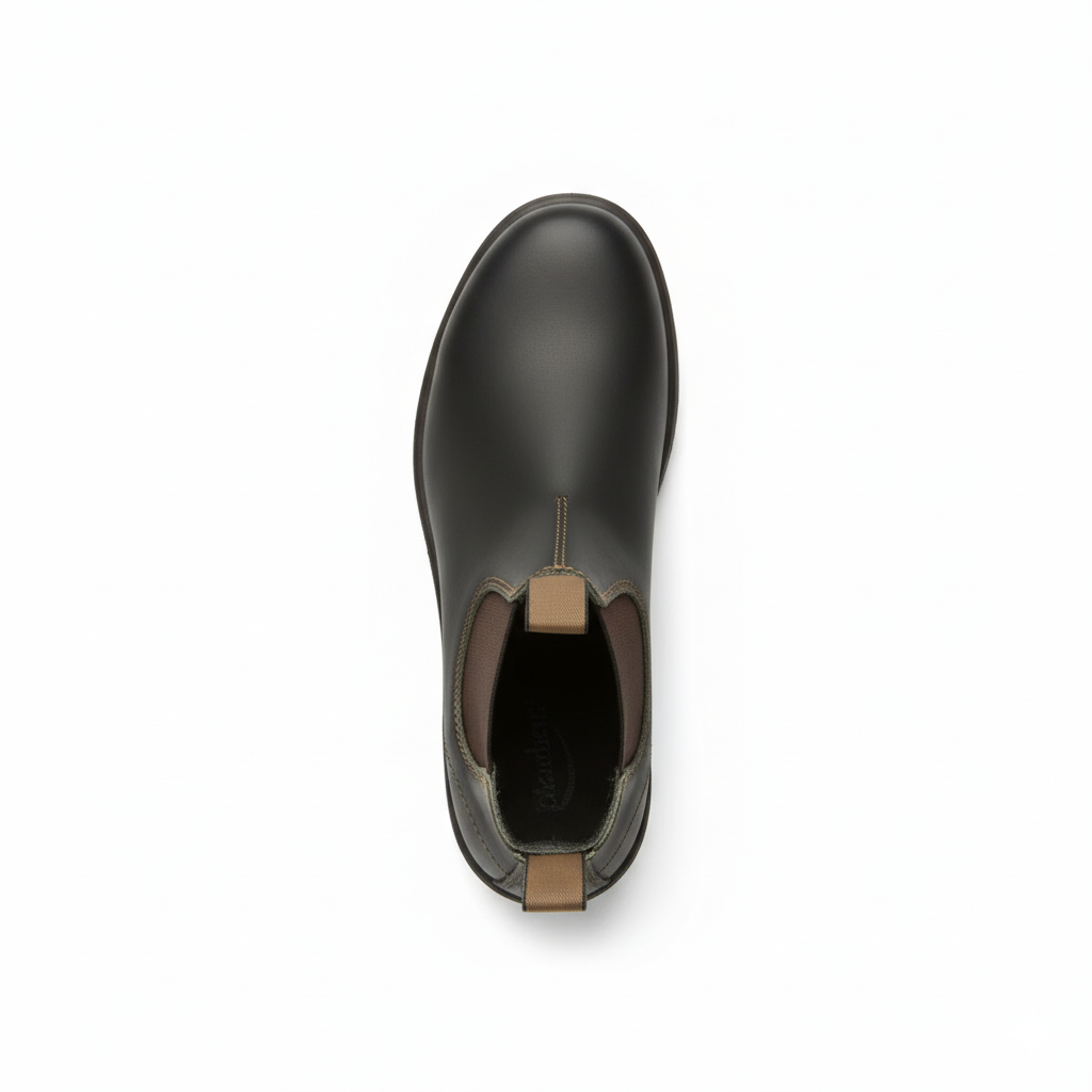 Top view of unisex green Chelsea ankle boots showing tan pull tab and elastic goring