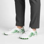 White and green barefoot shoes with wide toe box worn showing flexible design for natural movement and gym training