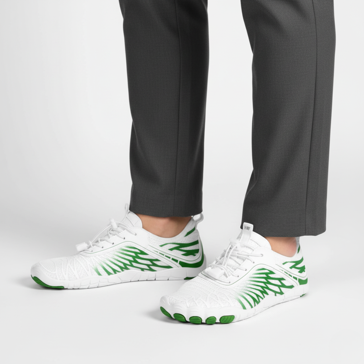 White and green barefoot shoes with wide toe box worn showing flexible design for natural movement and gym training