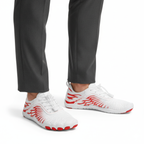 White and red flexible barefoot trainers with wide toe box worn showing natural foot movement design