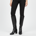 Black leather knee-high boots styled with black leggings for sleek, elegant appearance