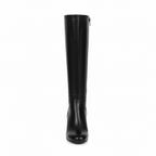 Front view of women's black leather knee-high boots with block heel and full-length zipper