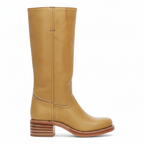 Side view of women's tan leather knee-high boots with wooden stacked block heel and full shaft